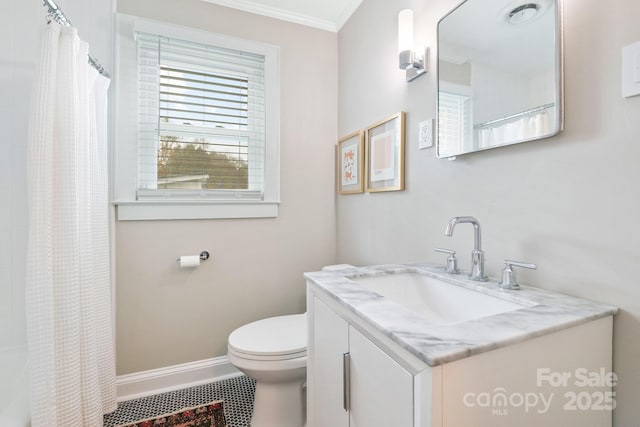 bathroom with toilet, vanity, ornamental molding, and walk in shower