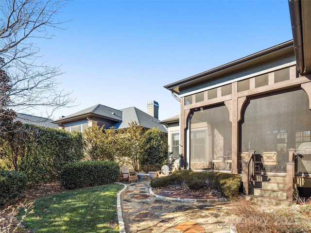 view of yard featuring a sunroom