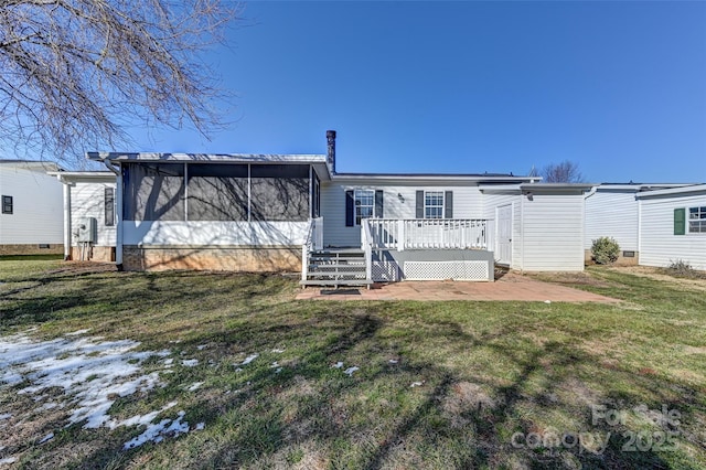 back of property with a sunroom, a yard, and a deck