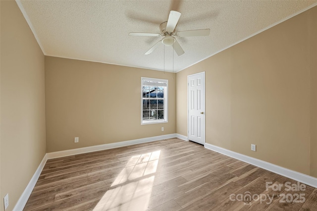 unfurnished room featuring ceiling fan, light hardwood / wood-style floors, a textured ceiling, and lofted ceiling