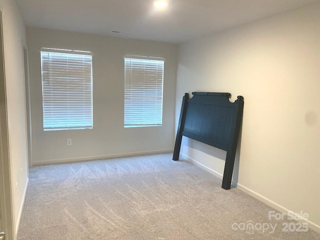 unfurnished bedroom with light carpet