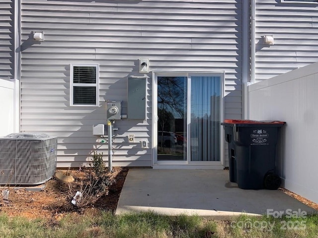 entrance to property with a patio area and central AC unit