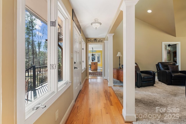 interior space with decorative columns and light hardwood / wood-style floors