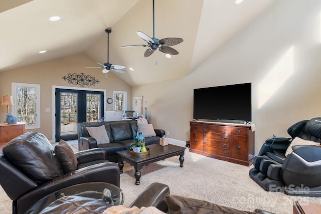 carpeted living room with high vaulted ceiling, french doors, and ceiling fan