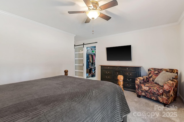 bedroom with ceiling fan, ornamental molding, light carpet, a walk in closet, and a barn door