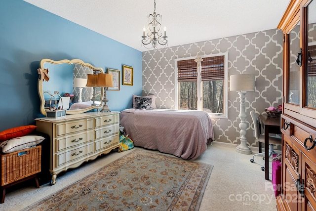 carpeted bedroom featuring an inviting chandelier