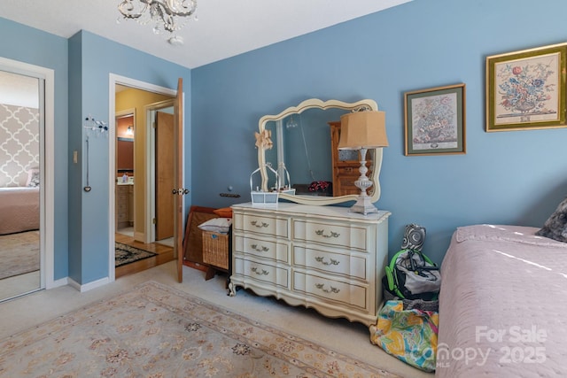 bedroom featuring a chandelier and light carpet