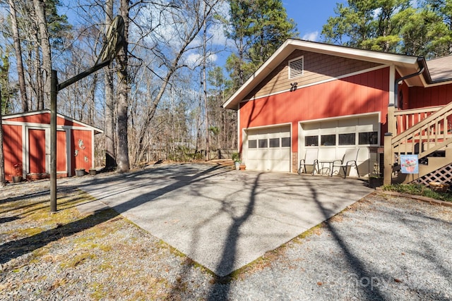 view of home's exterior featuring a garage and an outbuilding