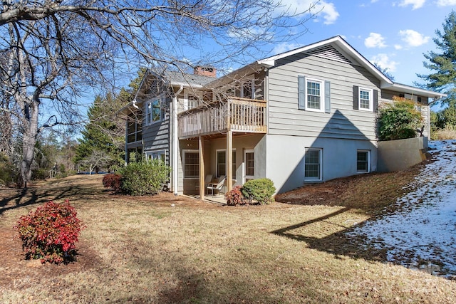 rear view of property featuring a yard