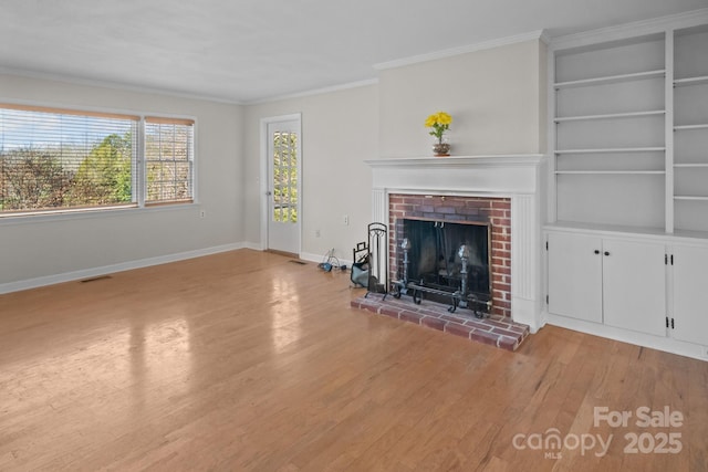 unfurnished living room with ornamental molding, a fireplace, and light hardwood / wood-style flooring