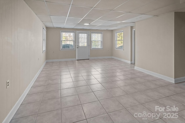 tiled spare room with a paneled ceiling