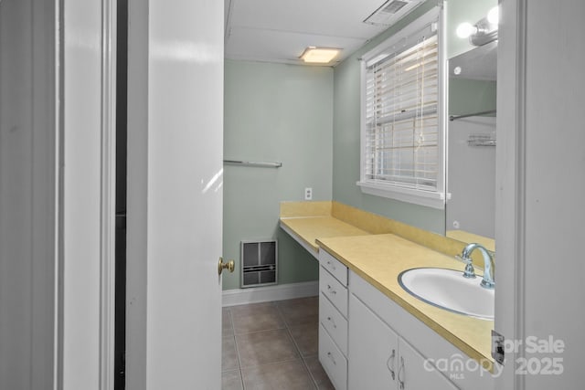 bathroom with heating unit, tile patterned floors, and vanity