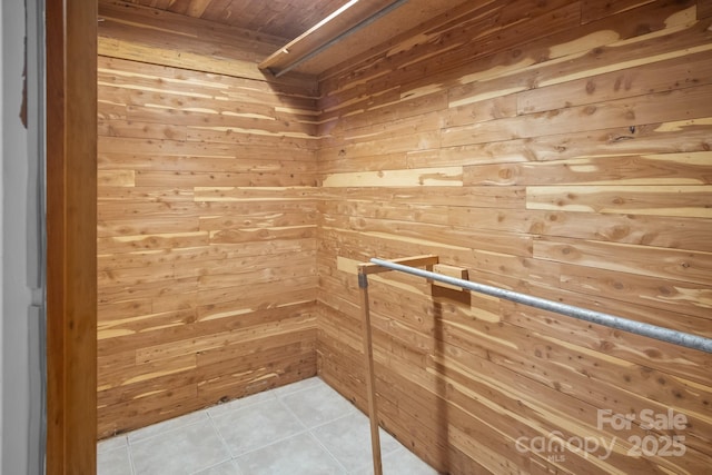 walk in closet with light tile patterned floors