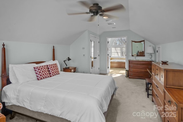 carpeted bedroom with ceiling fan, lofted ceiling, and connected bathroom