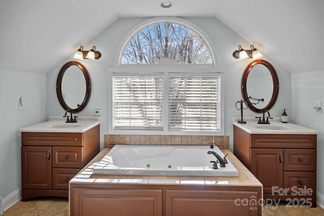 bathroom featuring a healthy amount of sunlight, lofted ceiling, and vanity