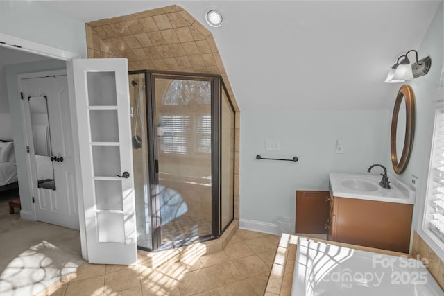 bathroom featuring a shower with door, lofted ceiling, tile patterned floors, and vanity