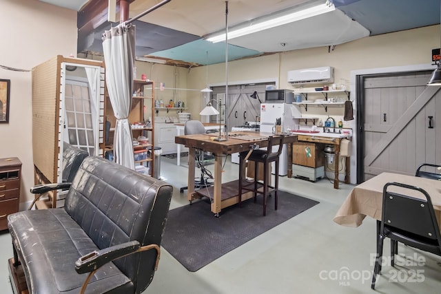 dining space featuring washer and dryer, a wall mounted AC, and a workshop area