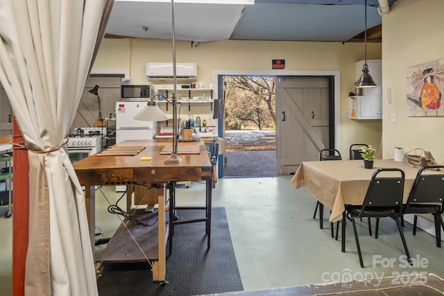 dining space featuring concrete floors and a wall mounted air conditioner