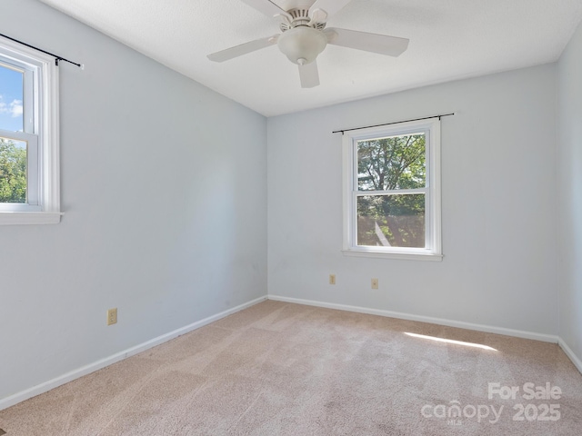 unfurnished room featuring ceiling fan and light carpet