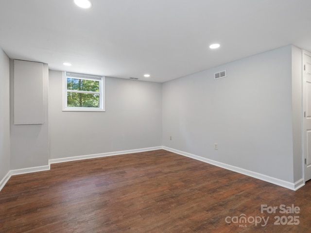 basement with dark hardwood / wood-style floors