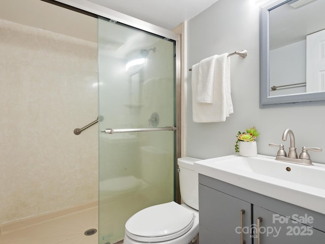 bathroom featuring toilet, an enclosed shower, and vanity