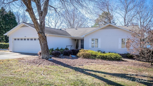 ranch-style home featuring a front lawn and a garage