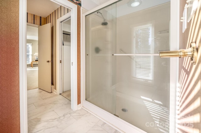 bathroom featuring a shower with door