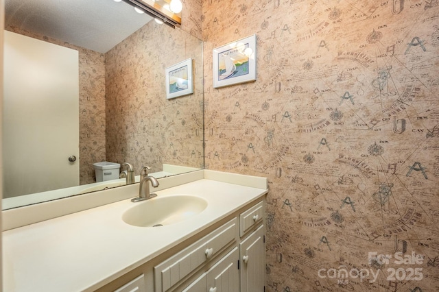 bathroom featuring toilet and vanity