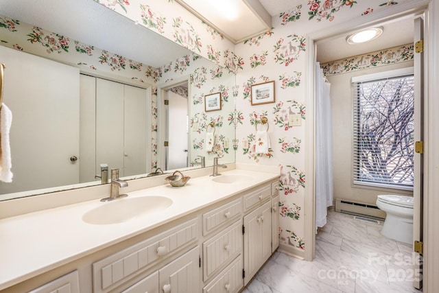 bathroom with toilet, vanity, and baseboard heating