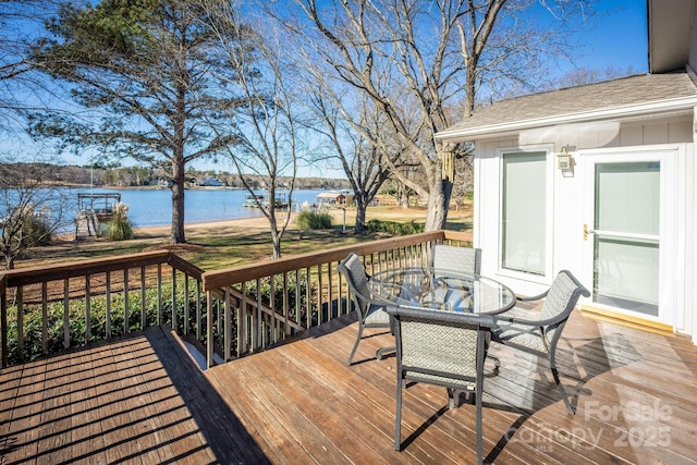 wooden terrace featuring a water view