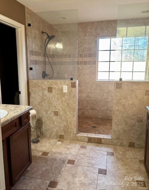 bathroom featuring vanity and a tile shower