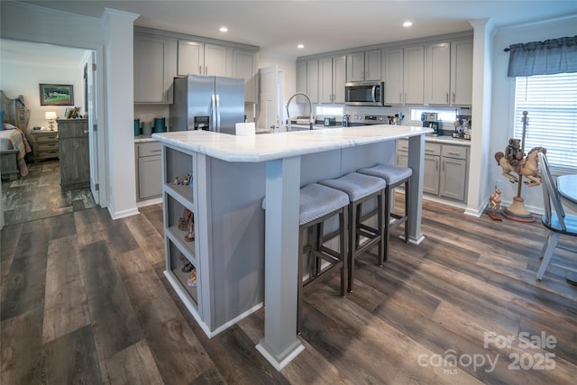 kitchen featuring appliances with stainless steel finishes, gray cabinets, and dark hardwood / wood-style floors