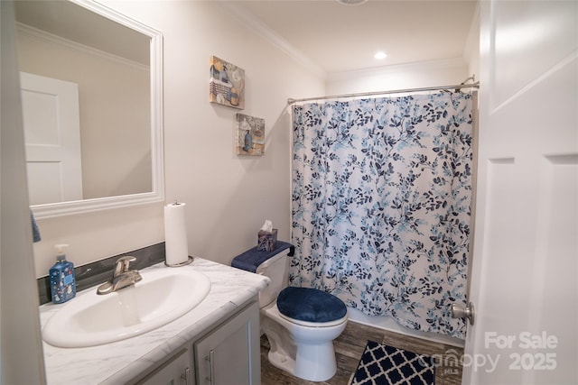 bathroom featuring toilet, hardwood / wood-style flooring, ornamental molding, and vanity