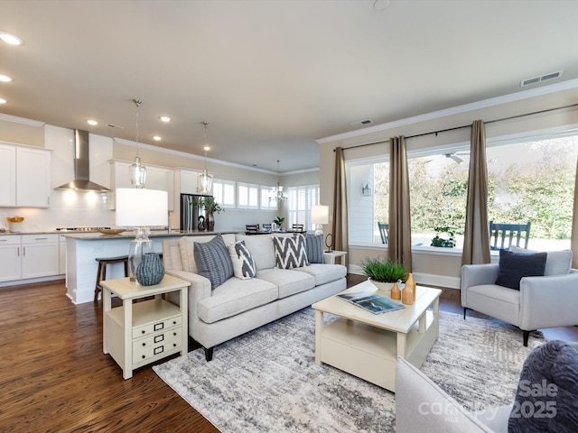 living room with crown molding, a notable chandelier, and dark hardwood / wood-style flooring