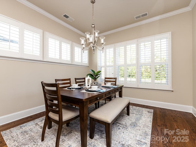 dining area with dark hardwood / wood-style flooring, crown molding, and a healthy amount of sunlight