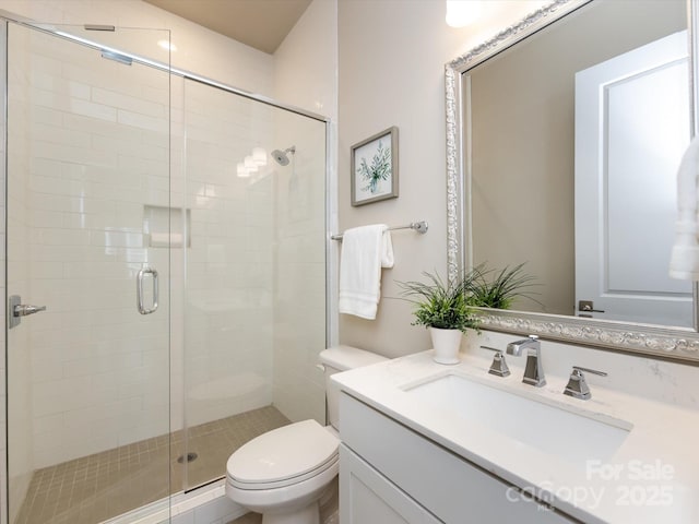 bathroom featuring vanity, toilet, and walk in shower