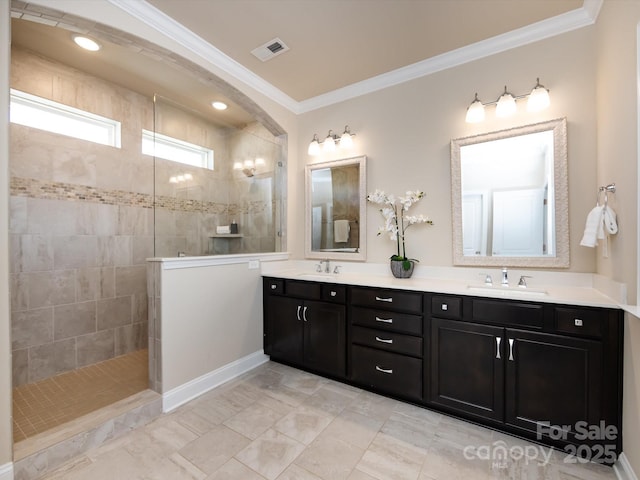 bathroom with ornamental molding, vanity, and a tile shower