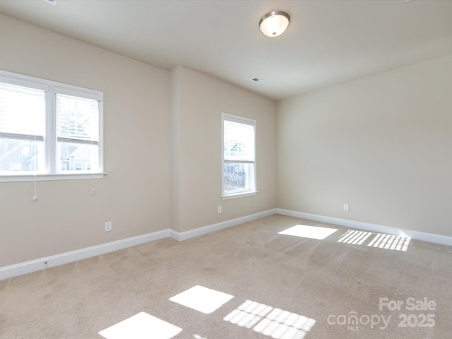 empty room featuring light colored carpet