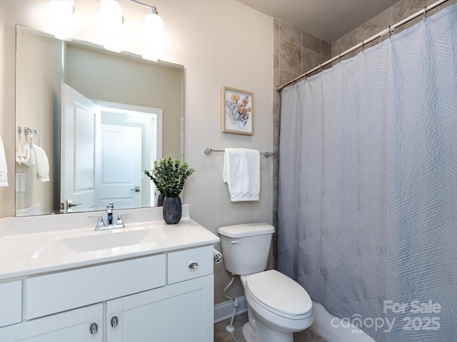 bathroom with vanity, a shower with shower curtain, and toilet