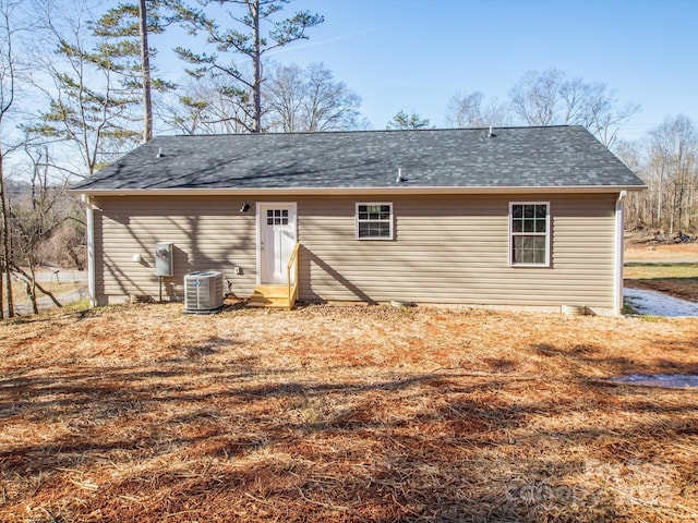 rear view of house featuring central air condition unit