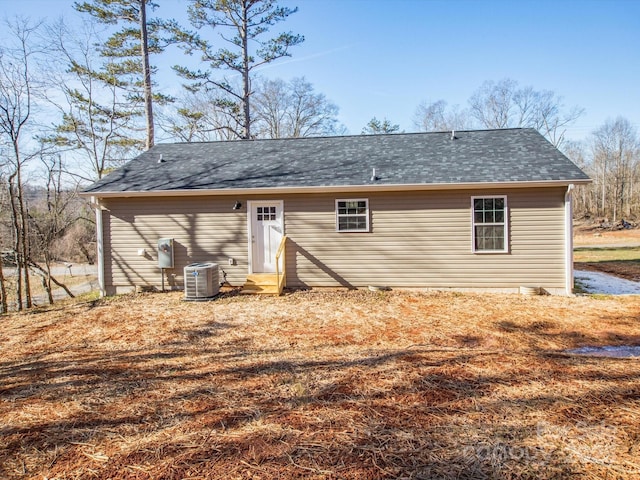 rear view of house featuring cooling unit