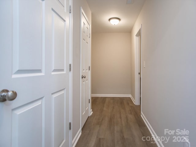 corridor featuring dark wood-type flooring