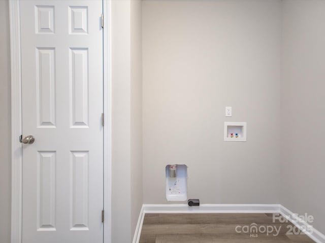 clothes washing area featuring washer hookup and hardwood / wood-style flooring