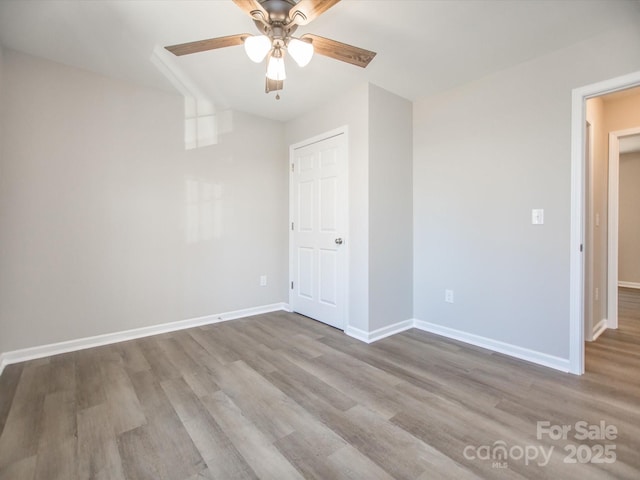 unfurnished bedroom with ceiling fan and light wood-type flooring