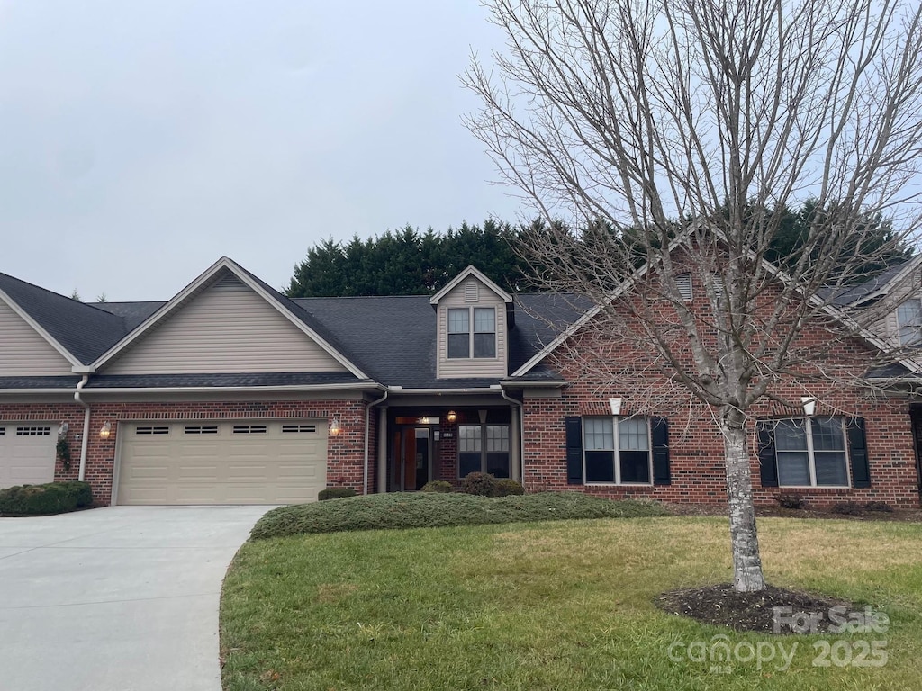 view of front of home with a garage and a front lawn