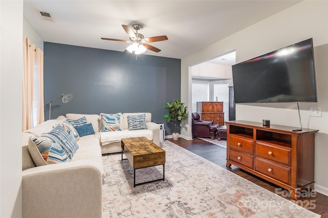 living room featuring ceiling fan and hardwood / wood-style floors