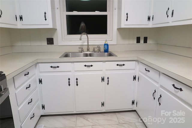 kitchen with sink and white cabinets