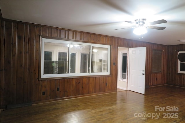 empty room with ceiling fan and dark hardwood / wood-style floors