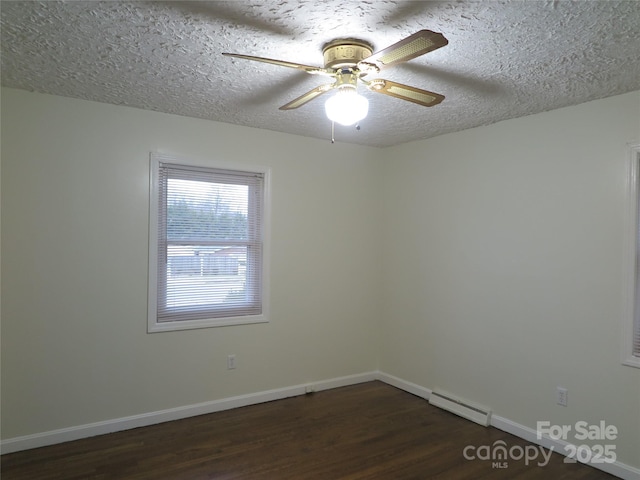 unfurnished room featuring a textured ceiling, baseboard heating, dark hardwood / wood-style flooring, and ceiling fan