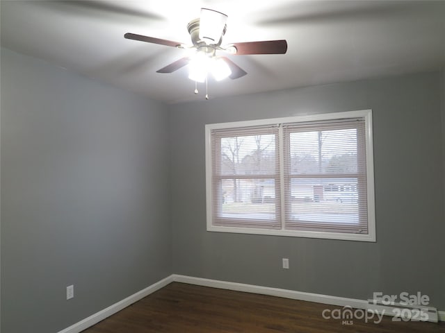 spare room featuring ceiling fan and dark hardwood / wood-style floors